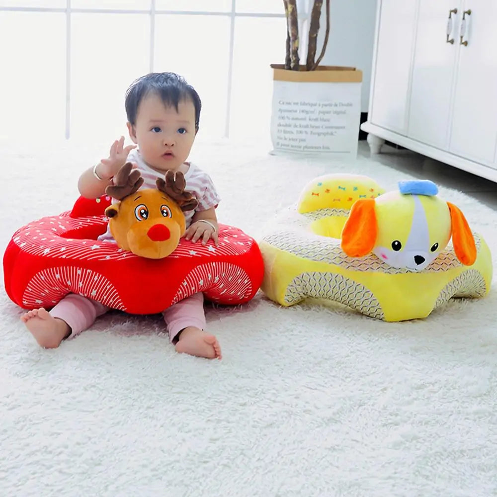 A baby sits on a white carpet, playing with two plush animal seats from Gigi & Jade Kids Co., each embodying an ergonomic design. One seat, shaped like a reindeer, features red with white stripes; the other is a yellow dog with orange ears. The Cute Baby Sofa aids cognitive development as the baby, in a white shirt and pink pants, reaches out eagerly.