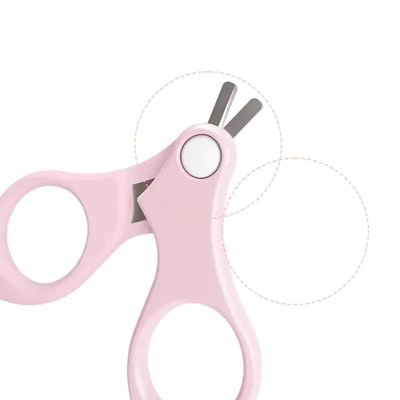 Gigi & Jade Kids Co.'s Baby Nail Care Set includes a pair of pink baby nail scissors designed with rounded tips for safe, tender nail care. The scissors feature two large finger holes for a firm grip and a small cutting blade, emphasizing a child-friendly design suitable for baby's sensitive skin.