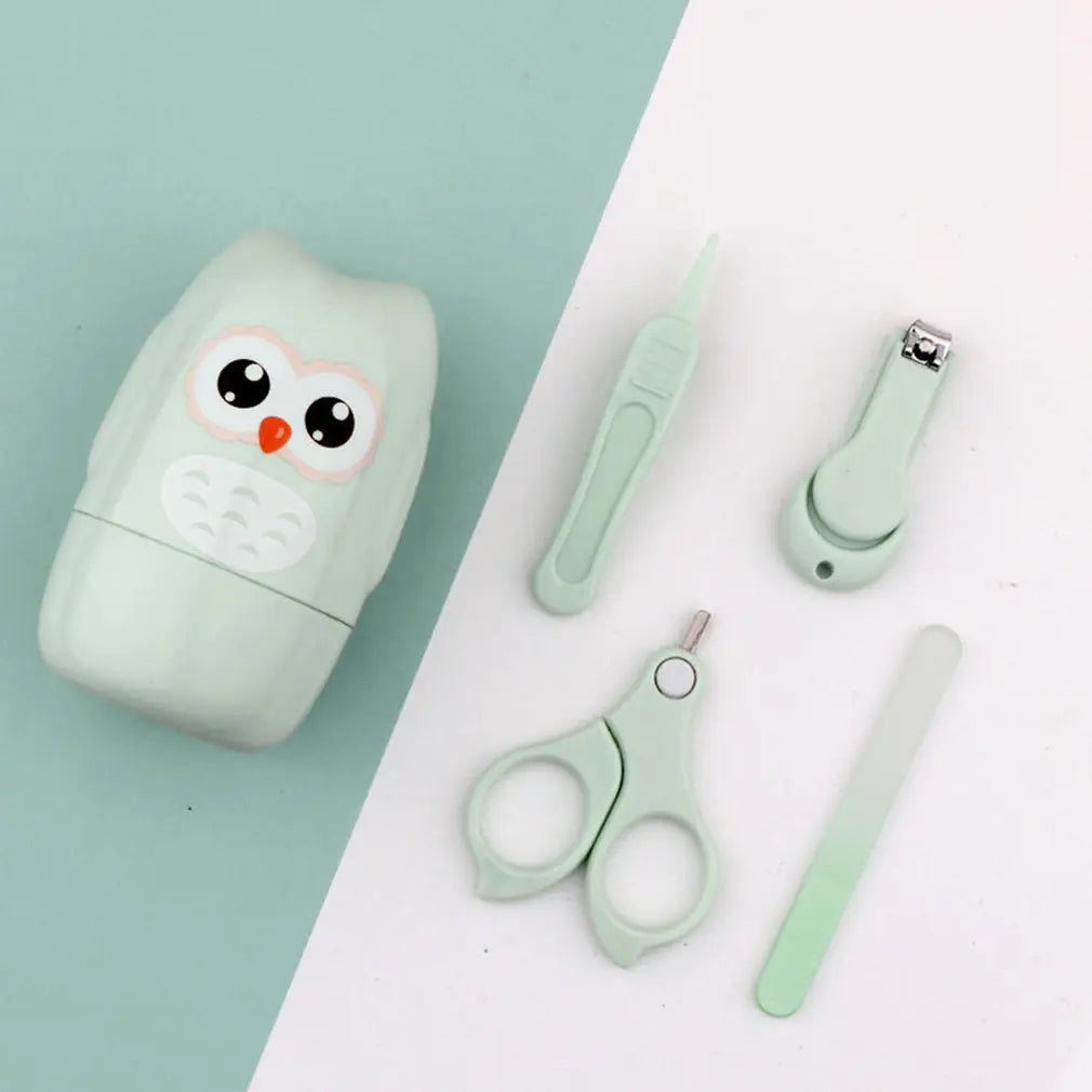 A Baby Nail Care Set by Gigi & Jade Kids Co. displayed on a two-toned background. The set features a pale green owl-shaped container, along with matching mint green scissors, nail clipper, file, and tweezers—all designed for gentle nail care that respects your baby's sensitive skin.