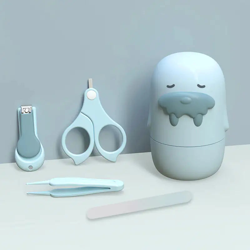 The Baby Nail Care Set by Gigi & Jade Kids Co. features a nail clipper, safety scissors, tweezers, and a nail file, all stored in an adorable walrus-shaped case. The items come in soft pastel colors—primarily light blue and white—against a light gray background to ensure gentle care for your baby's sensitive skin.